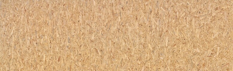 Neue große OSB Grobspanplatte - Textur von zusammengepressten braunen Holzstückchen in Panorama Nahaufnahme