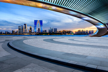 City square and skyline with modern buildings at night in Suzhou, Jiangsu Province, China.