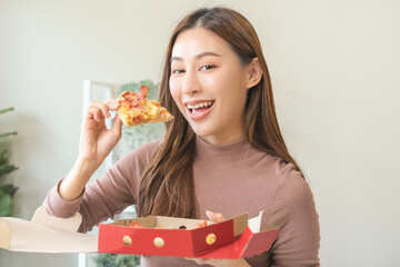 Happy meal with fast food, pleasure asian young woman, girl hold piece, enjoy eating delicious...