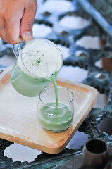 Fototapeta na wymiar green tea, milk green tea or iced matcha latte or pouring green tea