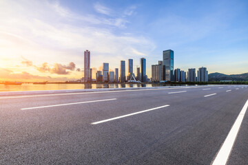 Asphalt highway road and city skyline with modern buildings at sunset in Zhuhai, Guangdong Province, China. Road and city skyline background.