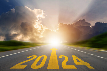 New year 2024 or straight forward concept. Text 2024 was written on the road in the middle of the...