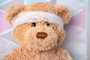 teddy bear with bandaged head, health care and treatment children through soft toy, medical therapy and pediatrics, safety for children