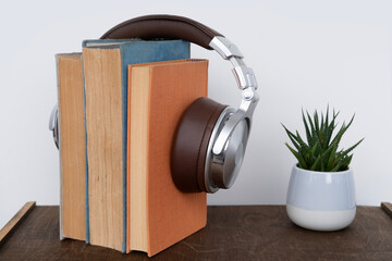 stack of books with headphones, learning foreign languages using audiobooks, multimedia learning,...