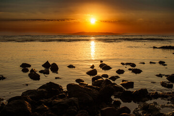 Tranquil Sunrise over Serene Ocean Shore