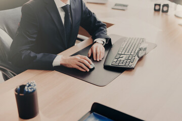 Focused businessman using computer at a sleek office desk