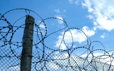 Lack of freedom concept, imprisonment. Barbed wire at restricted area