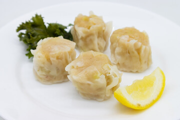 Japanese Ebi Shumai Shrimp Dumplings on a Plate with a Lemon