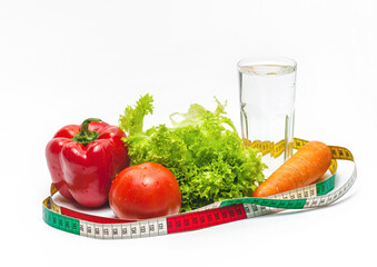Fresh vegetables with glass of water for healthy eating and drinking. Centimeter tape. Weight loss.
