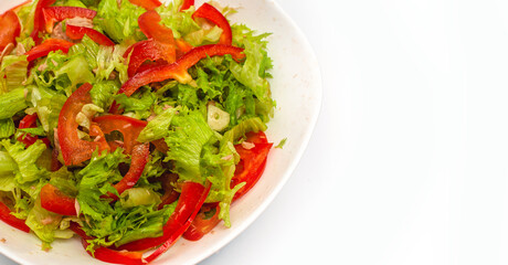 Raw chopped red pepper, lettuce and garlic in white bowl. Healthy vegetable background. Copy space.