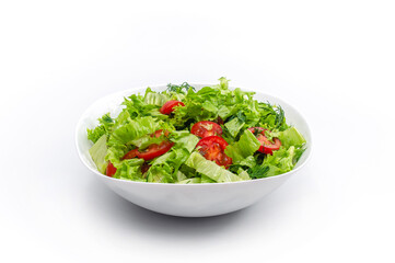 Front view of white bowl with vegetables isolated on white background. Green salad, dill, tomato.