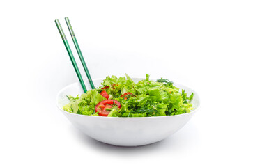 White plate of salad with vegetables isolated on white background. Wooden chopsticks for food.
