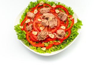 Tuna salad with lettuce, bell pepper, garlic and tomatoes isolated on white background. Copy space.