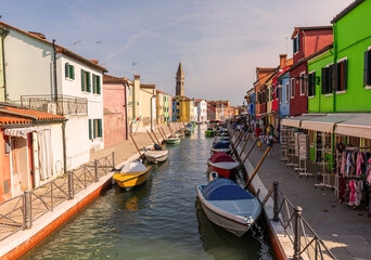 Burano island colorful houses place with canal and typical boats in Venice Italy