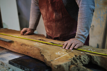 Measurement for cutting on raw wood, care taken. This ties to the artisanal trend of personalized...