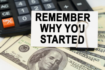 On the dollars there is a calculator and a business card with the inscription - remember why you...