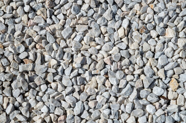 Small white and gray gravel on road closeup