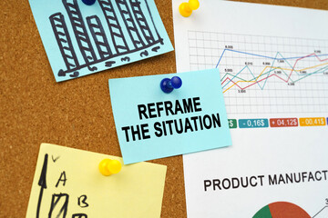 Business charts and stickers with the inscription hang on the board - REFRAME THE SITUATION
