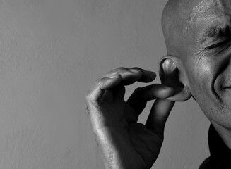 suffering from deafness and hearing loss on grey black background with people stock image stock...