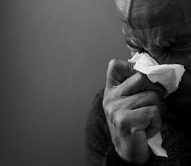 blowing nose after catching the cold and flu with grey background with people stock image stock photo - obrazy, fototapety, plakaty