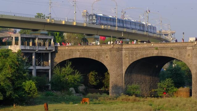 30 November 2023, Pune Metro Near Chhatrapati Shivaji bridge Built in 1924, this Heritage bridge built during the British rule by Raobahadur Ganpatrao Mahadeo Kenjale, Pune, Maharashtra, India.