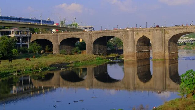 30 November 2023, Pune Metro Near Chhatrapati Shivaji bridge Built in 1924, this Heritage bridge built during the British rule by Raobahadur Ganpatrao Mahadeo Kenjale, Pune, Maharashtra, India.