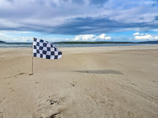 Checked white and flag racing flag on Narin strand by Portnoo, County Donegal, Ireland