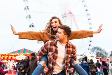 Happy couple having fun at amusement park in London - 688100401