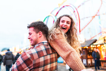 Happy couple having fun at amusement park in London