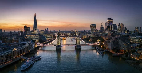 Fotobehang Panoramic aerial sunset view of the skyline of London, England, with Tower bridge and the City skyscrapers © moofushi