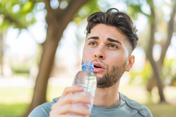 Sport man with a bottle of water at outdoors