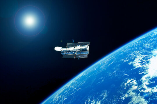 Space telescope over the planet. Elements of this image furnished by NASA