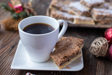 Cup of coffee with christmas pastry or cookies on wooden table