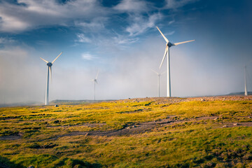 Electric turbines in the morning fog. Splendid summer view of Faroe Islands, Kingdom of Denmark,...