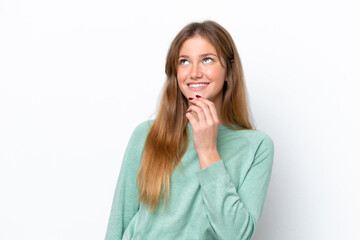 Young caucasian woman isolated on white background looking up while smiling