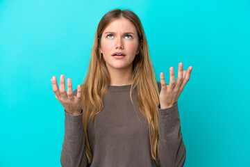 Young blonde woman isolated on blue background stressed overwhelmed