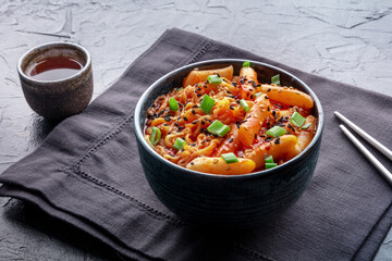 Rabokki, tteokbokki or topokki with ramen, Korean street food, spicy rice cakes in red pepper gochujang sauce, a popular dish