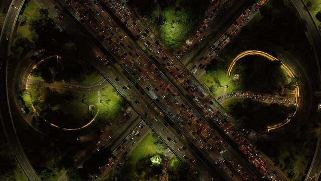 night time illumination jakarta city center famous traffic street road interchange aerial topdown panorama 4k indonesia