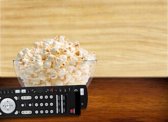 Popcorn in a bowl and classic TV remote control
