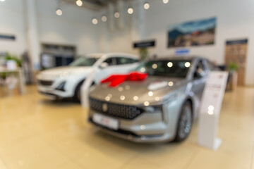 Blurred new car parked in modern showroom waiting for sales.