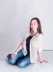 modest girl smiling sitting on the floor