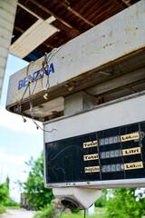 Old run-down gas station with gas pumps as a lost place in Wallachia in Romania