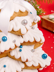 Gingerbread Christmas tree on red background. New Year or Christmas card. Decorated gingerbread with icing
