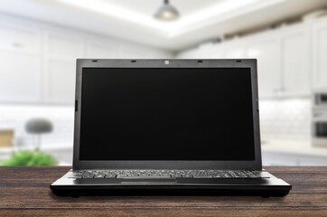 Fototapeta premium Modern laptop with black blank screen on desk