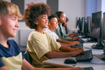 Multi-Cultural Group Of Secondary Or High School Students At Computers In IT Class 