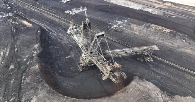 Aerial drone view of a large bucket wheel excavator in action in a open pit lignite mine.