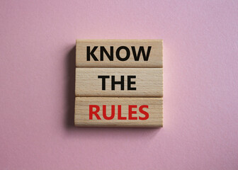 Know the rules symbol. Wooden blocks with words Know the rules. Beautiful pink background. Business...