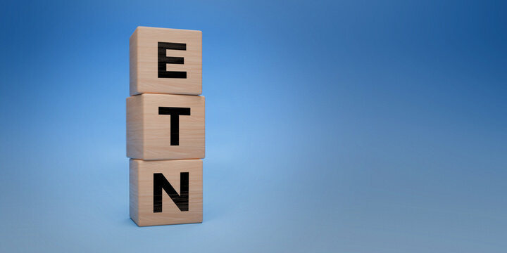 Wooden blocks with ETN acronym, exchange-traded notes concept, financial investment vehicles, blue background with space for text, debt security and market investment concept