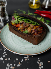 Baked pork neck with grilled vegetables and tomato salsa in toasted bread