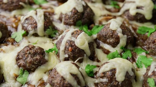 French onion beef meatballs baked in oven. Rotating video